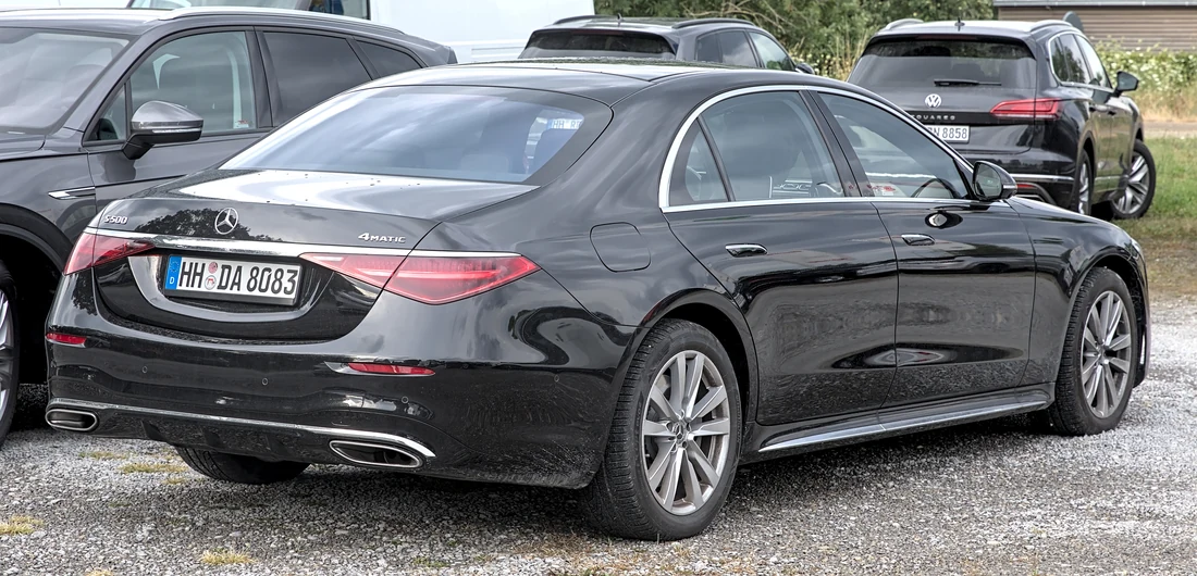 Black Mercedes-Benz S-Class luxury sedan in a rear three-quarter view.